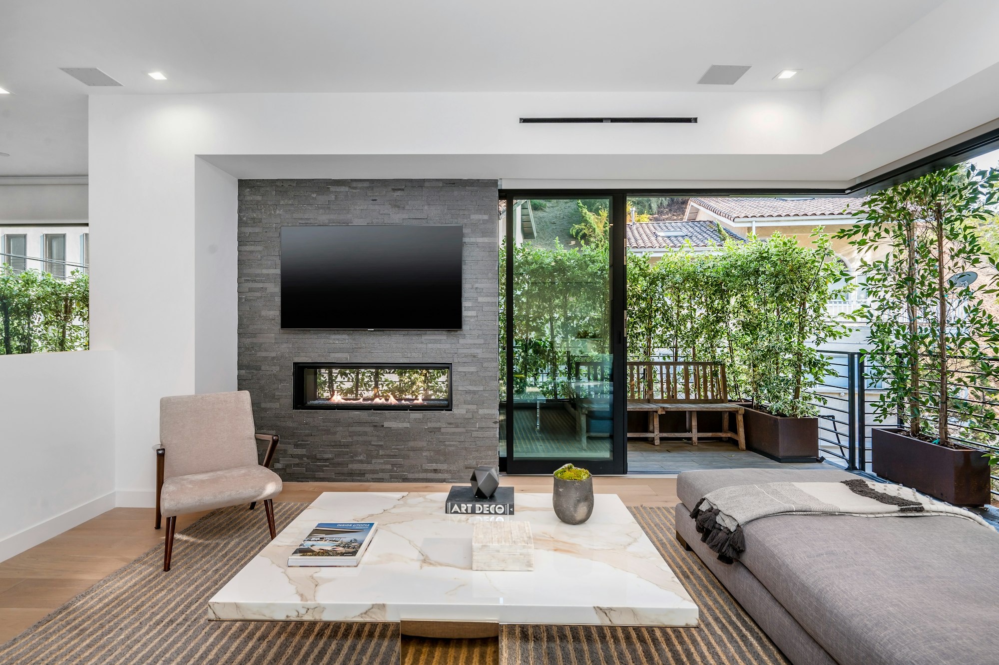 a living room with a tv mounted on the wall above a fireplace