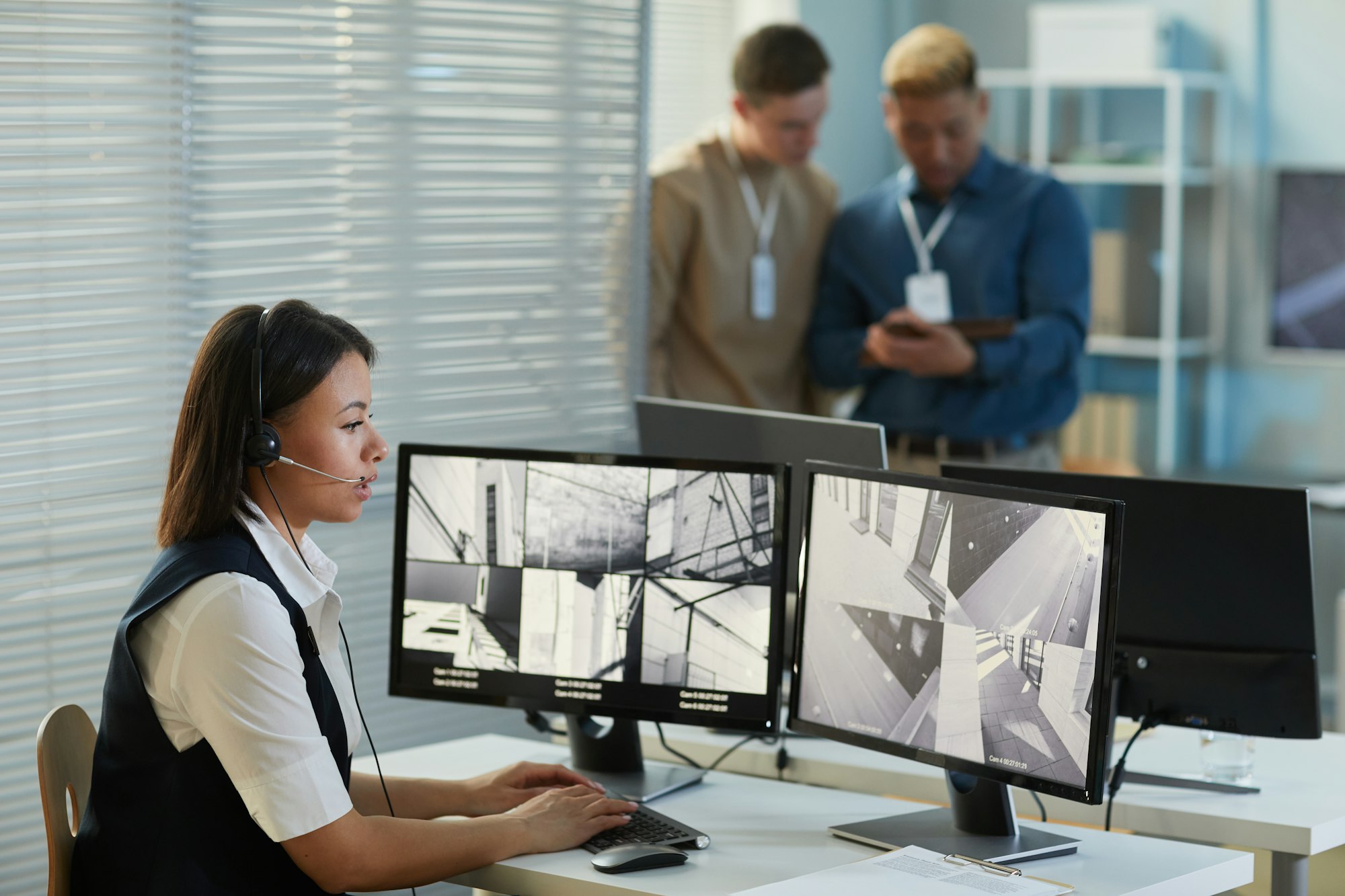 Young woman watching surveillance camera