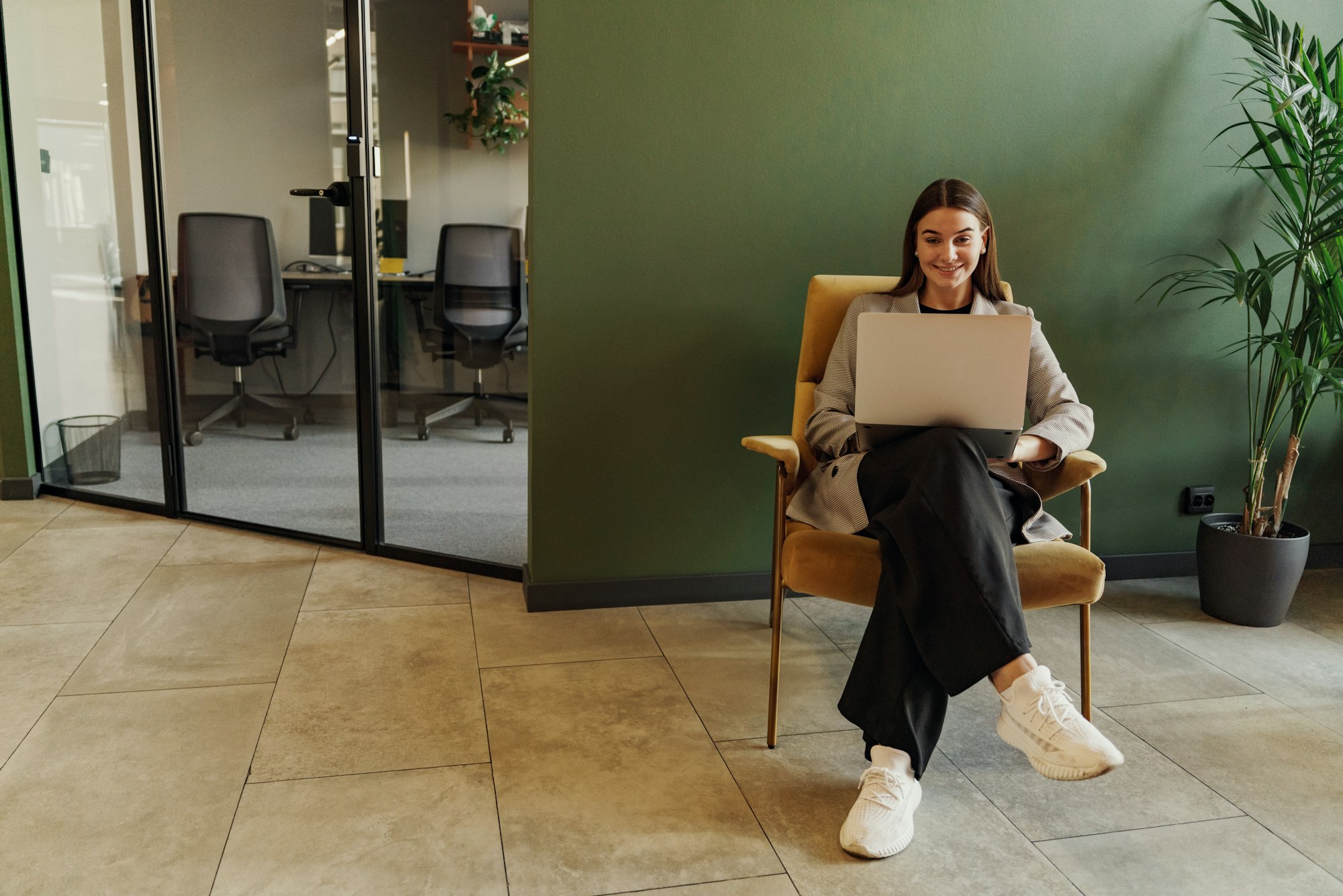 In the chair, a commercial business woman working in an online office in business clothes