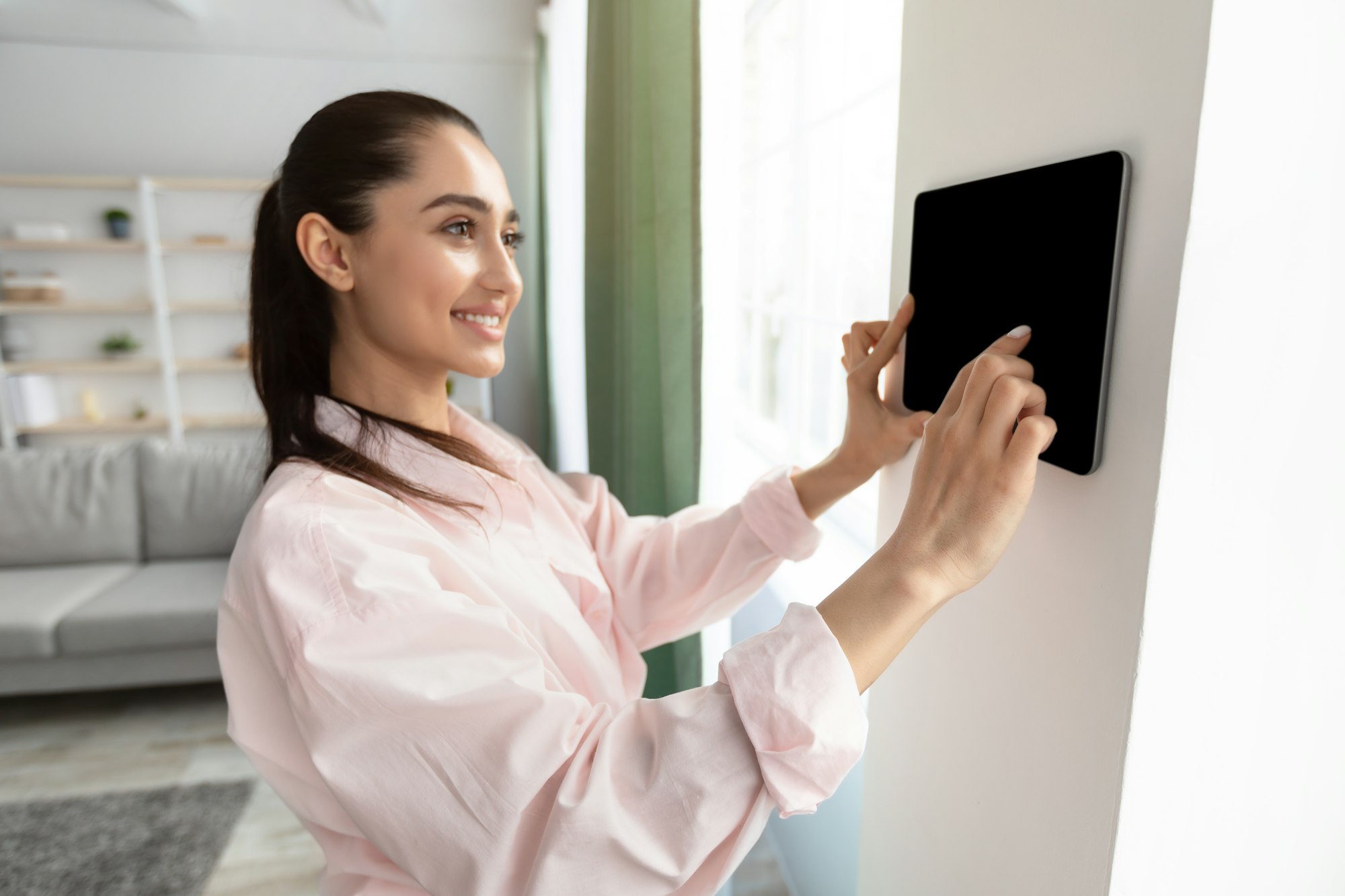 Woman using smart wall home control system